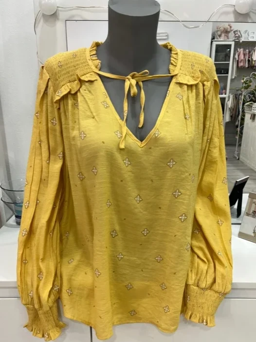 Blusa amarilla con estampado y detalles fruncidos
